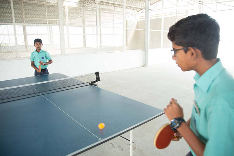 table tennis playing image - Suguna International School